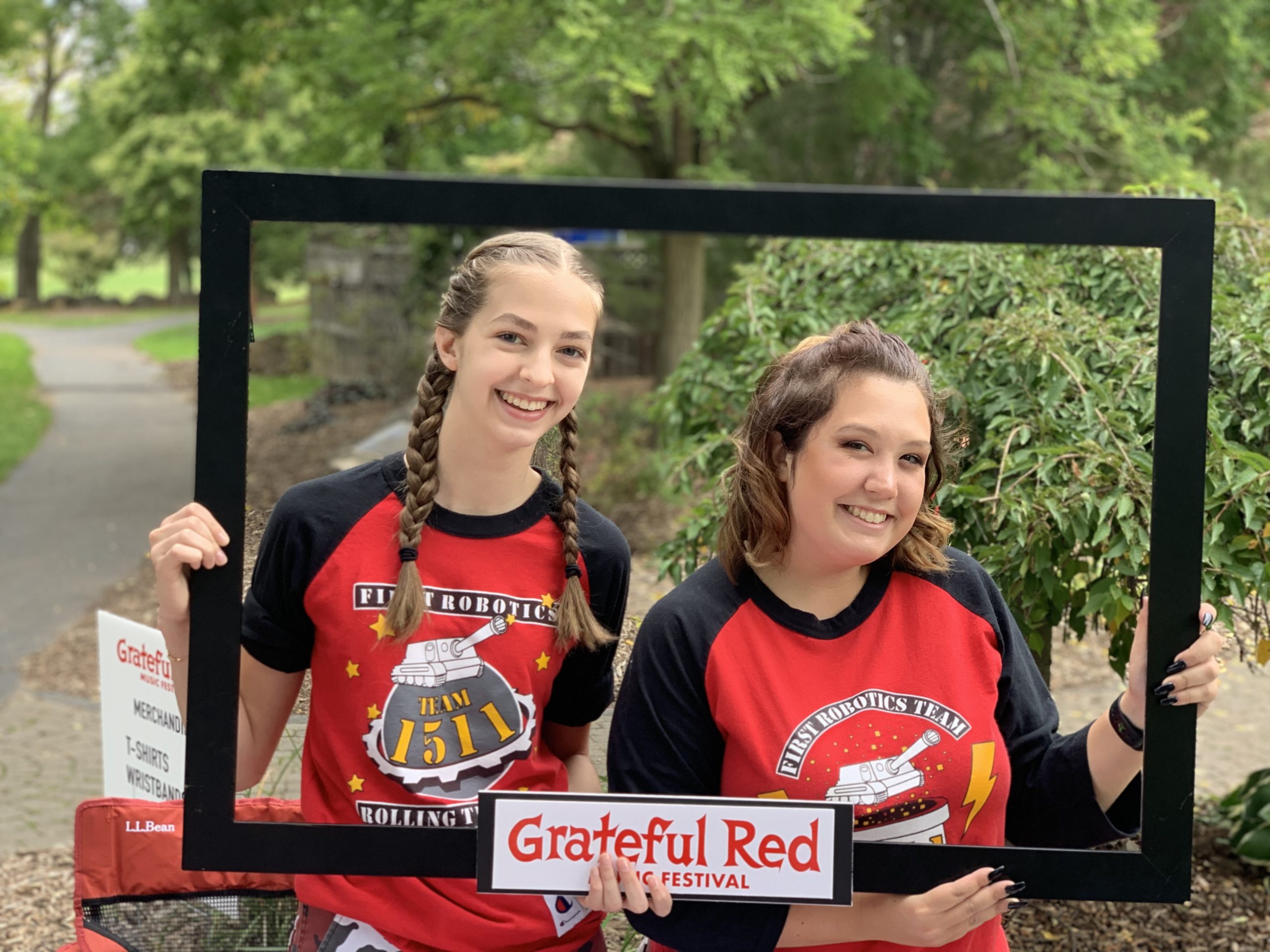 Photo of 2 students holding a Grateful Red Music Festival Frame