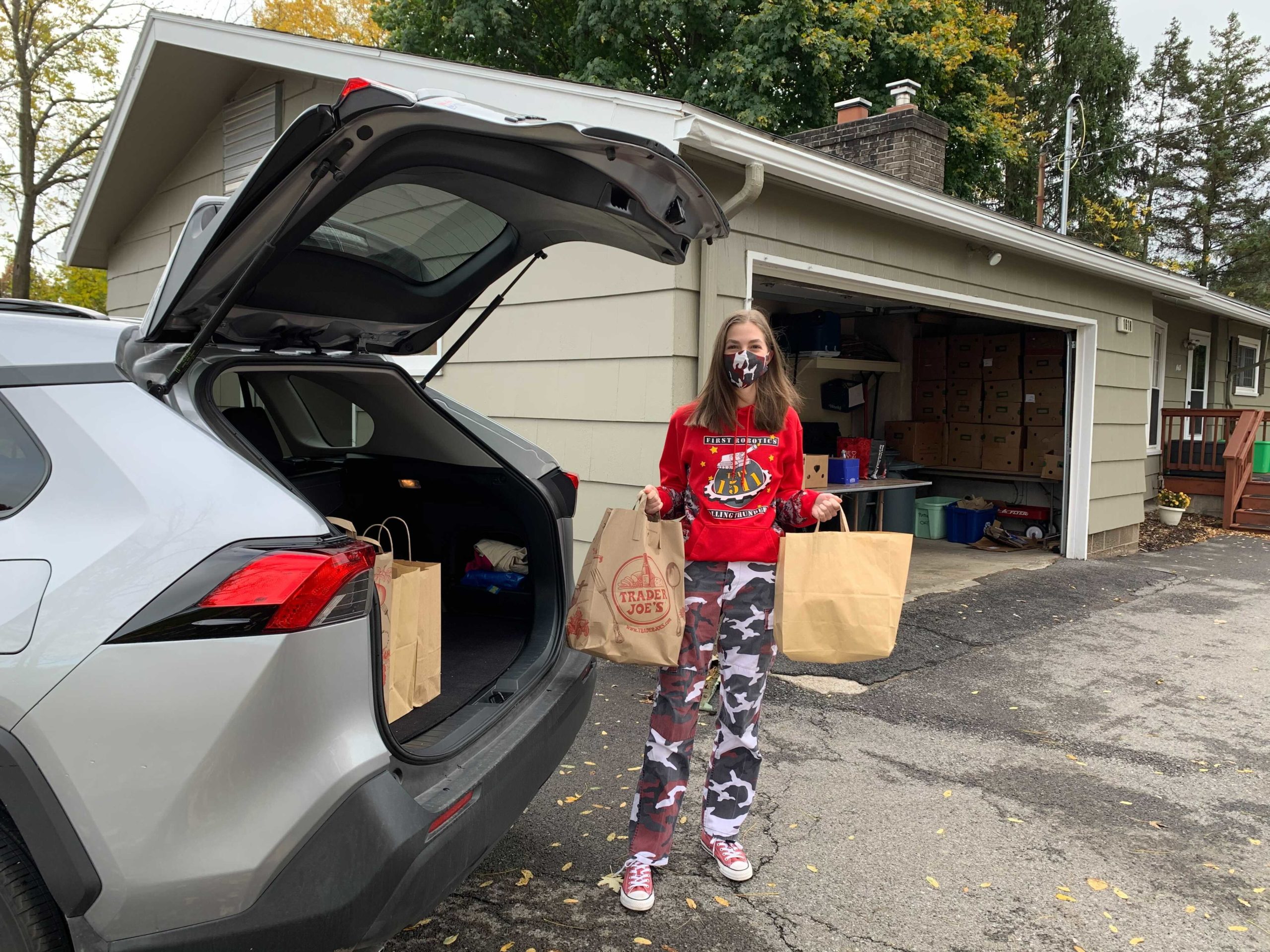 Student unloading bags of donations at the Penfield Ecumenical Food Shelf