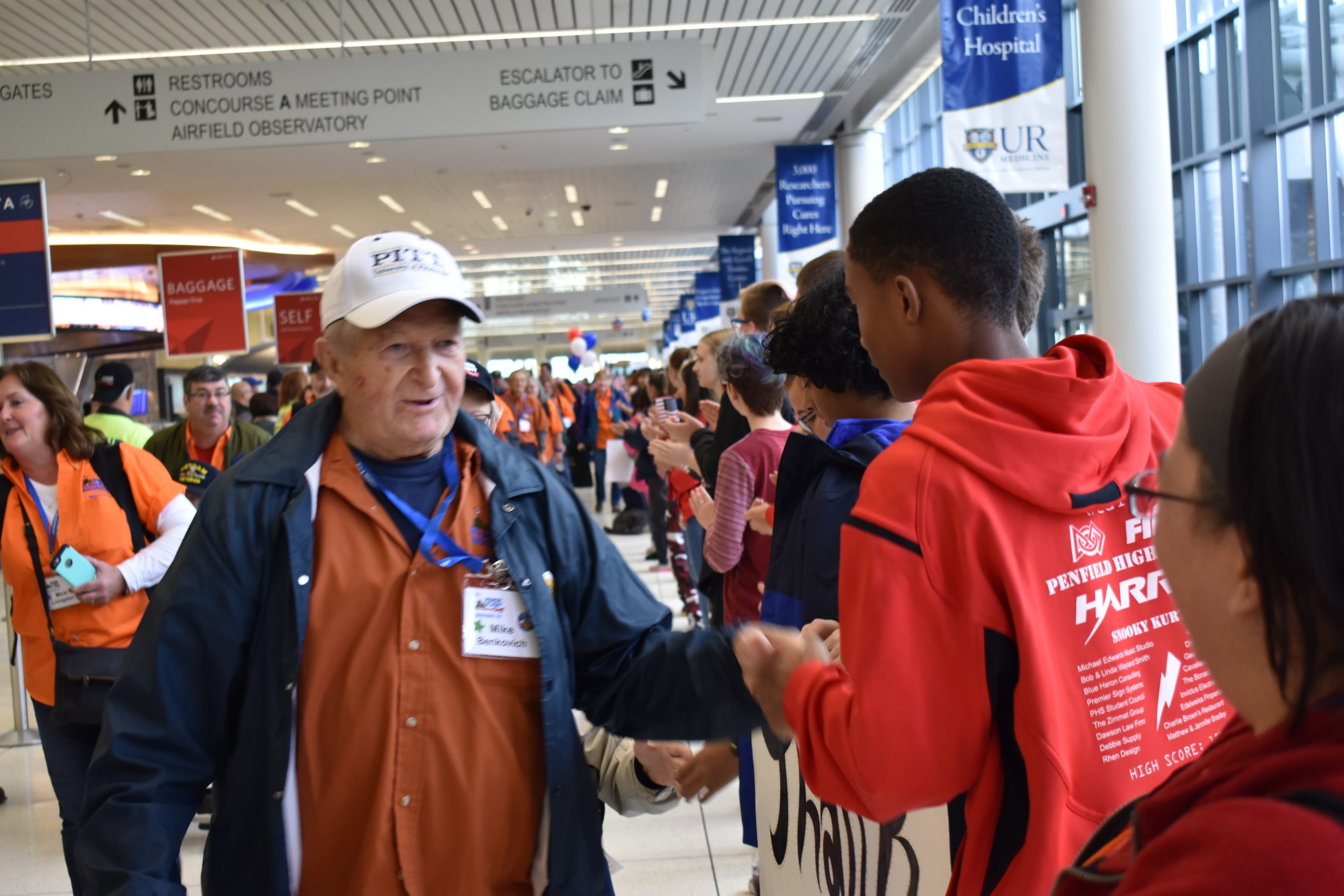 Team member greeting a veteran at Honor Flight