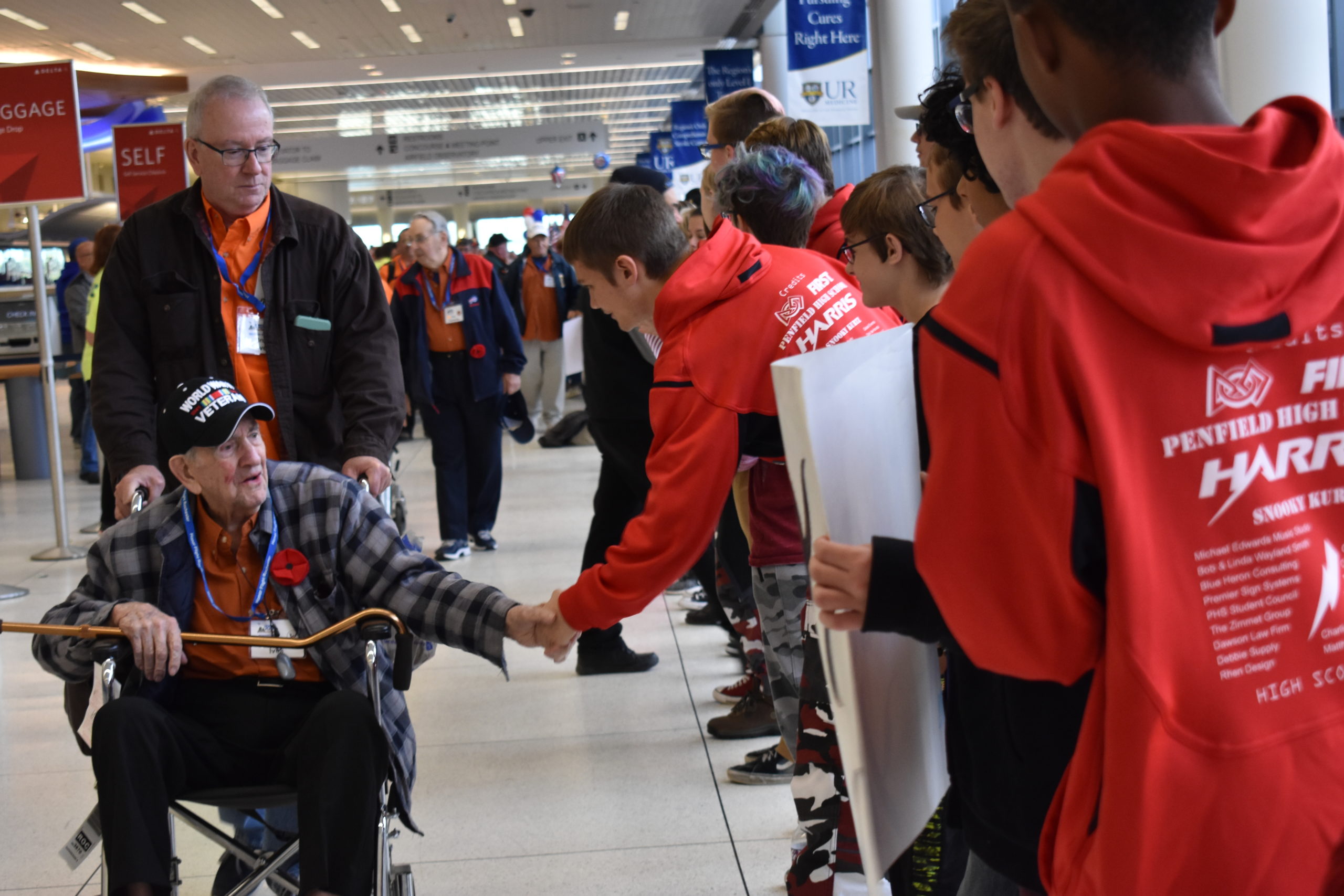 Student greeting a veteran at Honor Flight