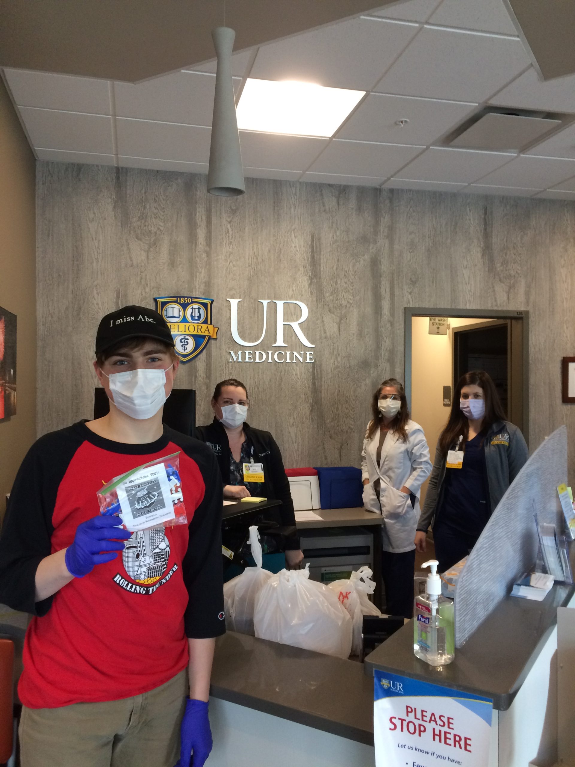 Team member delivery food and surgical mask straps to UR Medicine office