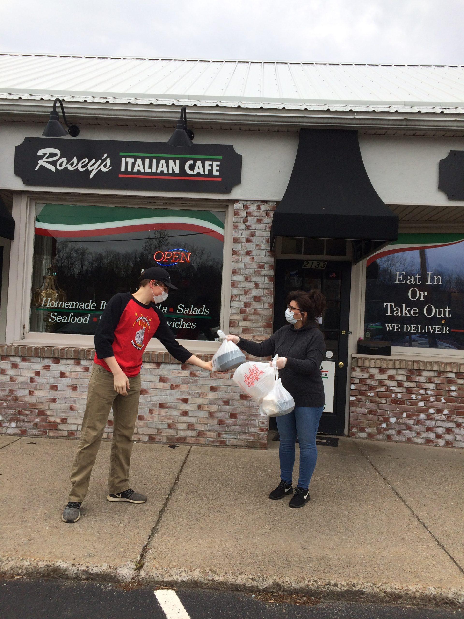 Team member picking up food at Rosey's Cafe to deliver to healthcare workers