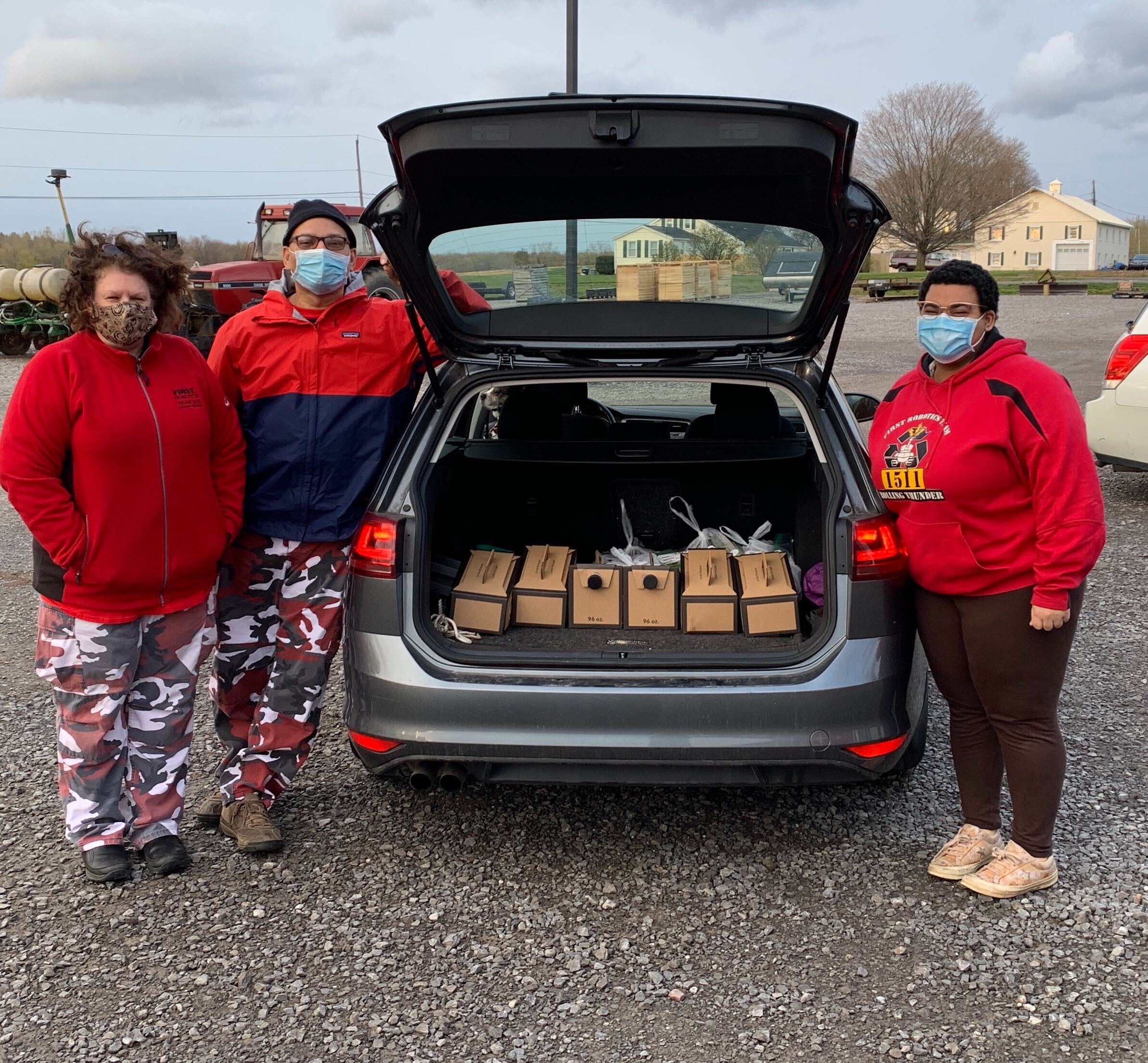 3 people standing by trunk full of boxes of coffee for Rochester General Hospital
