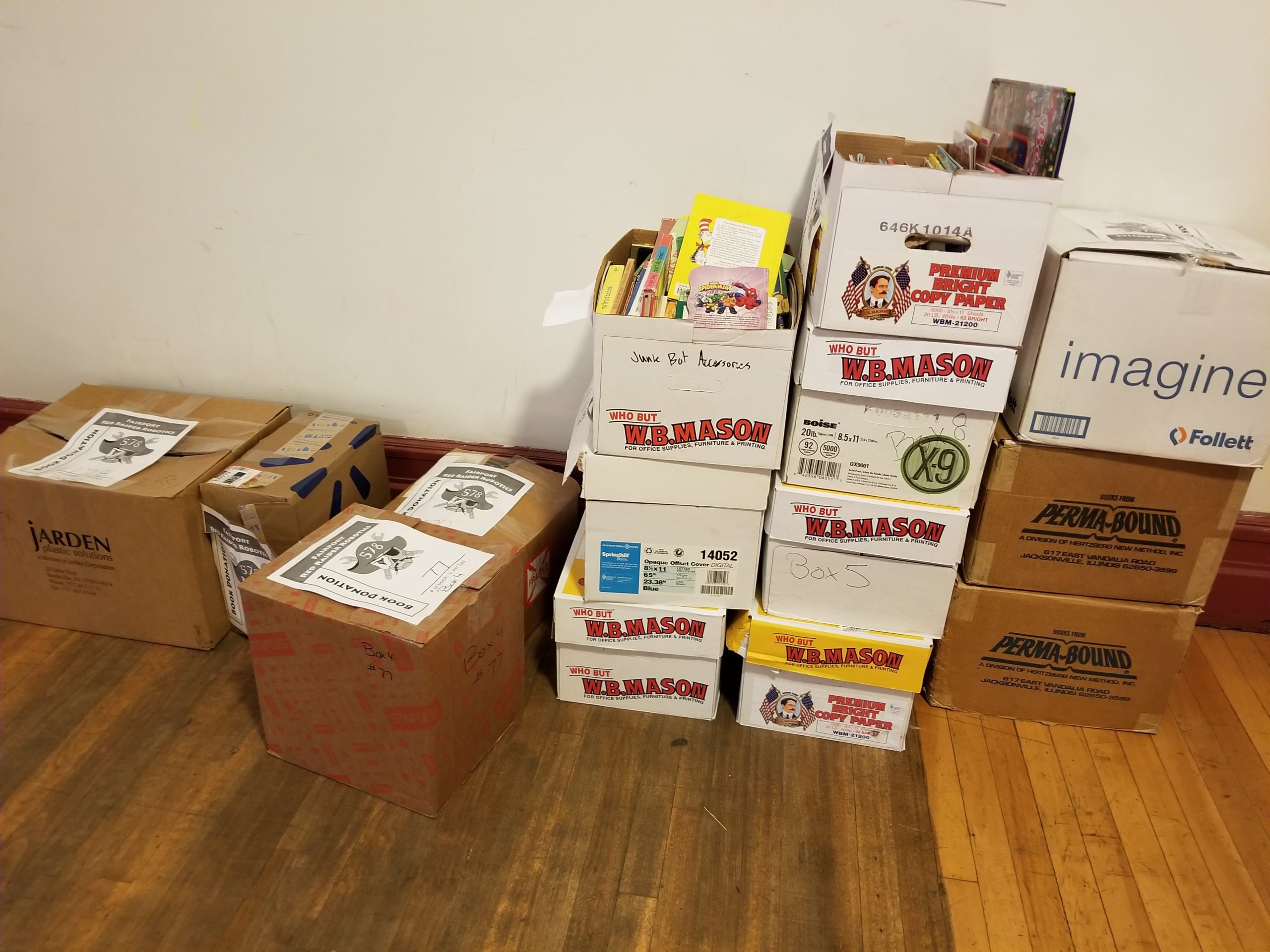 Photos of boxes of books donated at Rochester Ruckus