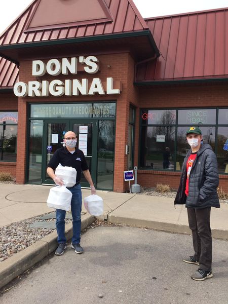 Student picking up food from Don's Original Restaurant for Health Care Workers